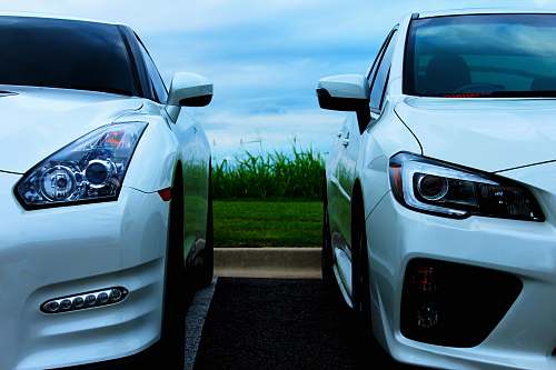 sports car white Nissan GT-R and white Mitsubishi Lancer Evolution 10 automobile